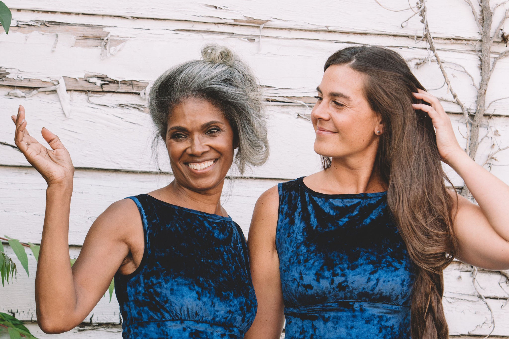 Blue velvet dress worn by a older black woman and a younger white woman