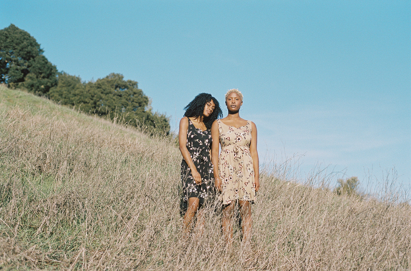 2 black women in wrap dresses 