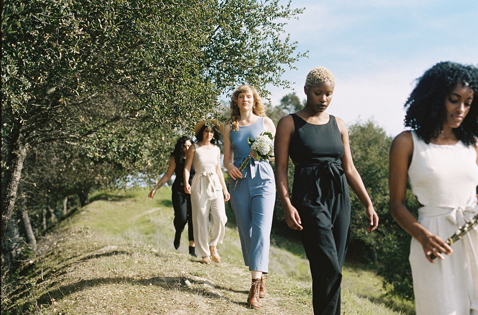 group of women walking in jumpsuits