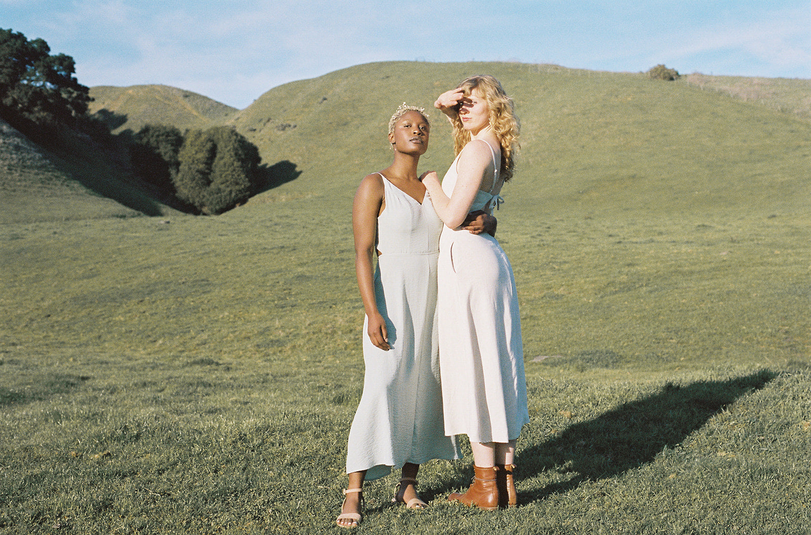 women wearing dresses blocking the sun 