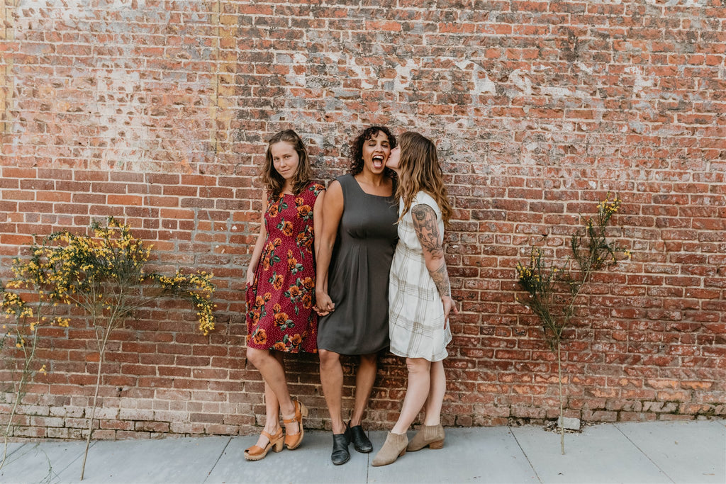 women kissing wearing dresses