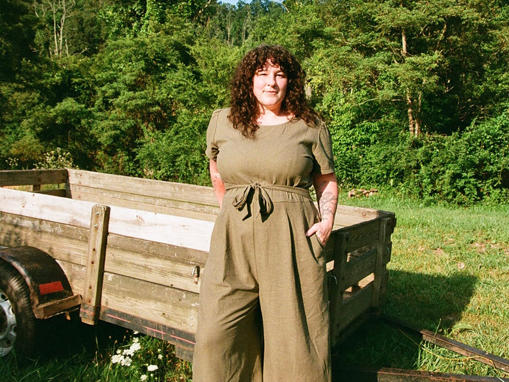 emily of whiskey dog wears in a olive linen vega jumpsuit