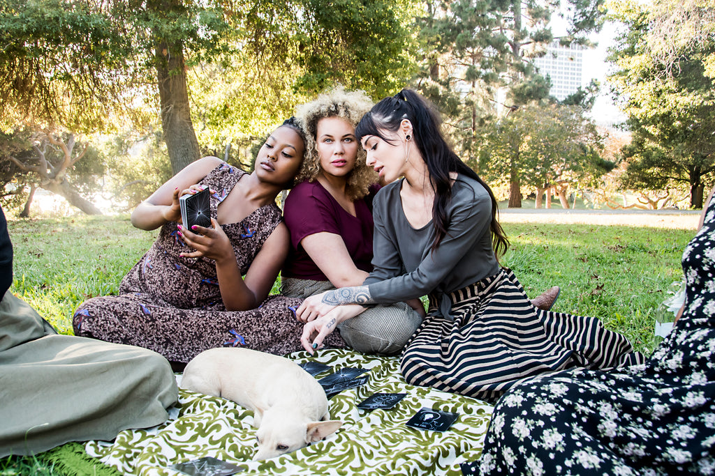 women at the lake merit reading tarot cards wearing field days fall collection 