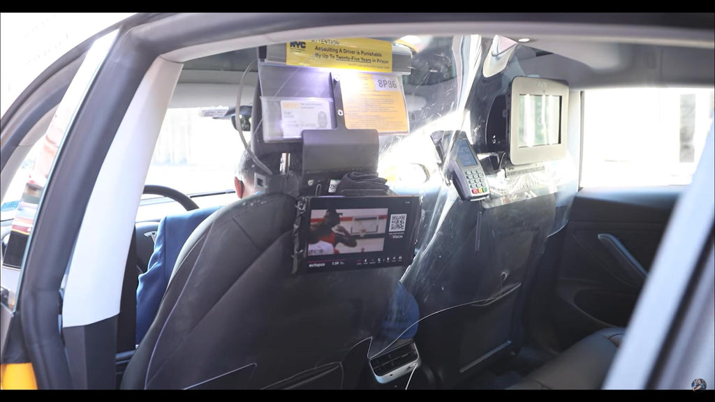 Tesla Model 3 taxicab back seat with payment option.