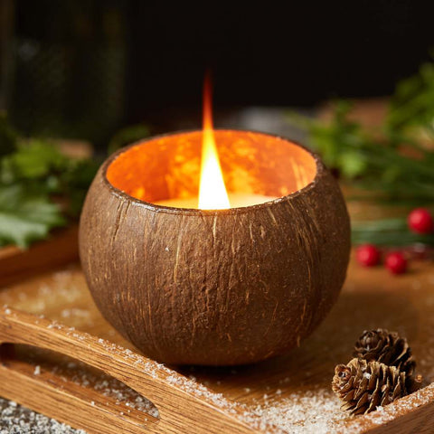 Coconut shell candle with a flame