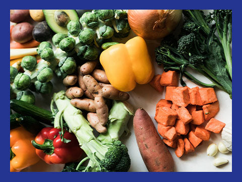 A variety of fresh vegetables spread out on a counter top