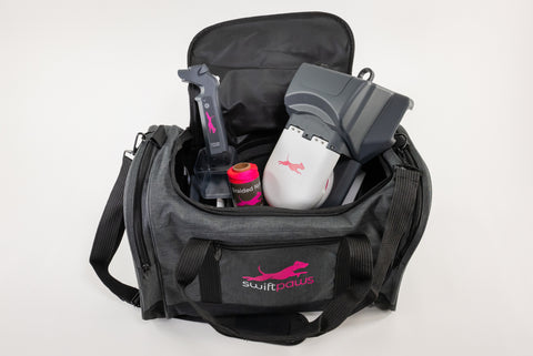 An open SwiftPaws Duffel Bag with an assortment of items