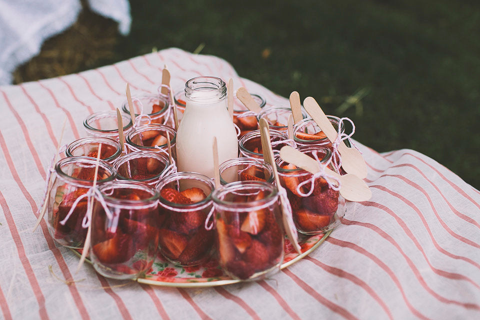 Strawberrys and cream in individual glasses.