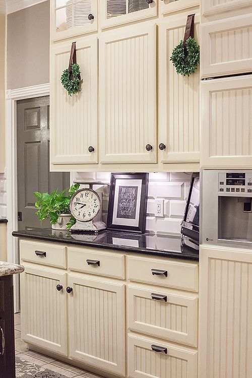 Farmhouse kitchen with beadboard cabinet facings