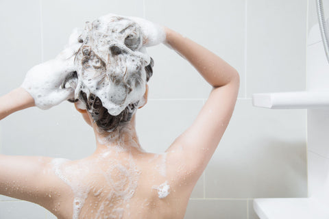 woman washing her hair in the shower