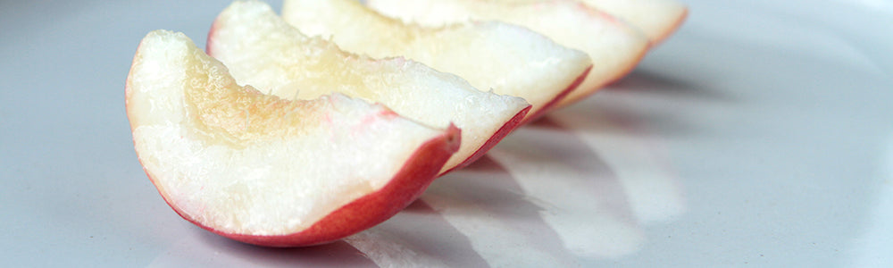 Slices of peaches laid in a row