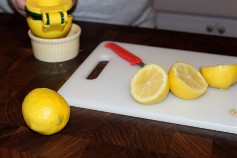 Lemons being cut on a cutting board