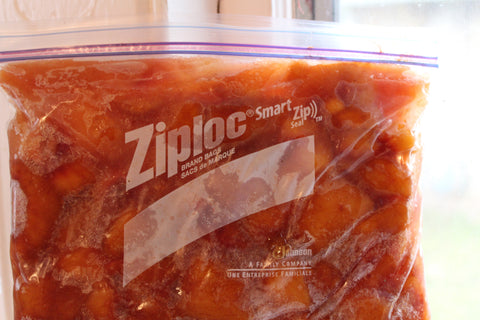 Ziploc bag filled with peaches, ready to freeze
