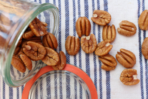 Pecans spilling from a mason jar