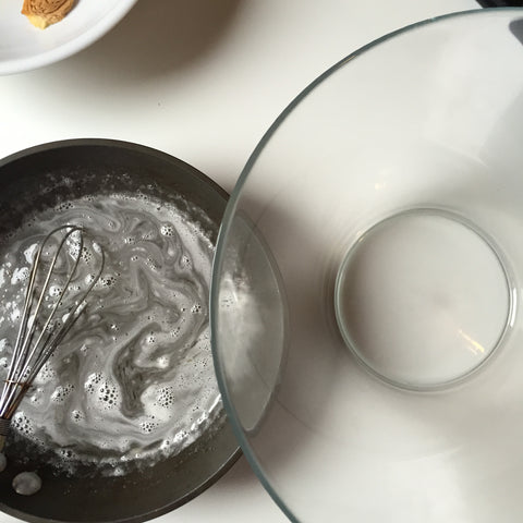 Glass mixing bowl set next to the sugar gelatin mixture