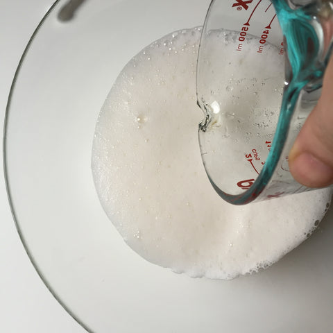 Adding the champagne to the mixing bowl