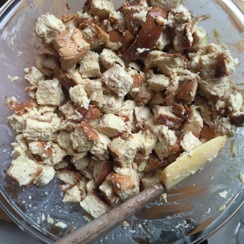Bread crumbs being mixed with bread pudding ingredients