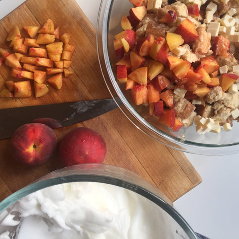 Slices of peaches being added to the bread mixture