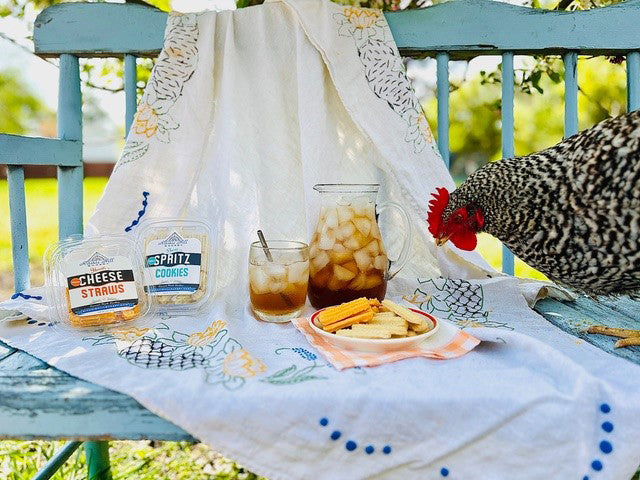 southern sweet tea cheese straws and spritz cookies outside on vintage tablecloth with chicken