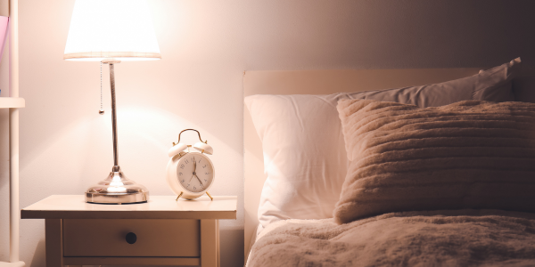 a comfortable bedroom in warm light setting