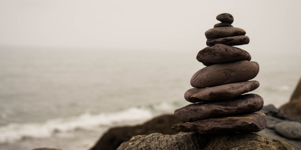 stones stacked on top of one another along the seaside