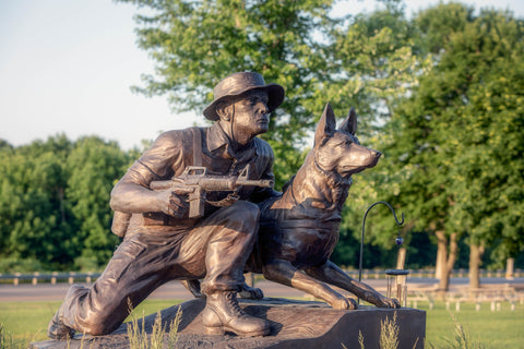 A statue of a solider and a war dog.