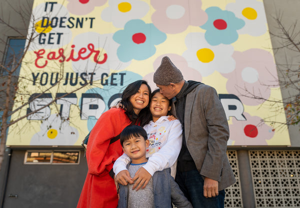 Maika's family standing in front of her mural in Oakland
