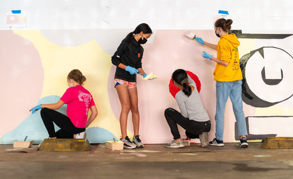 Girls painting Maika's mural