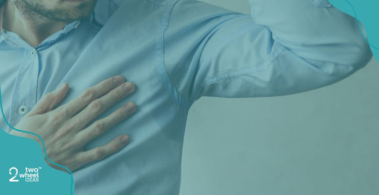 a man looking at the sweat in his armpits at work