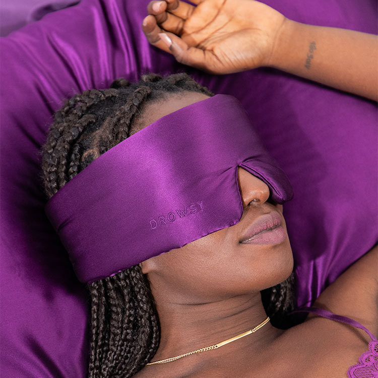 Girl Sleeping in bed with Drowsy Silk sleep mask covering eyes