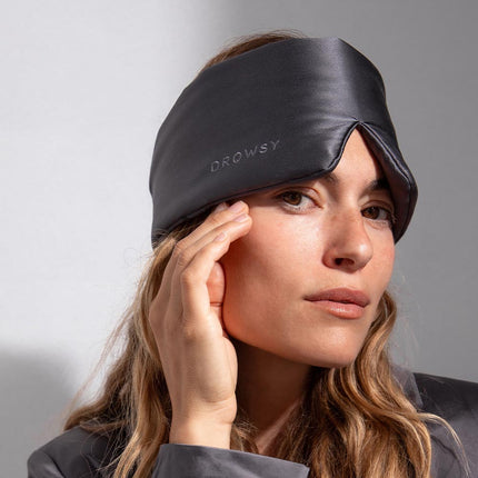 Model with a grey Drowsy silk sleep mask on her head