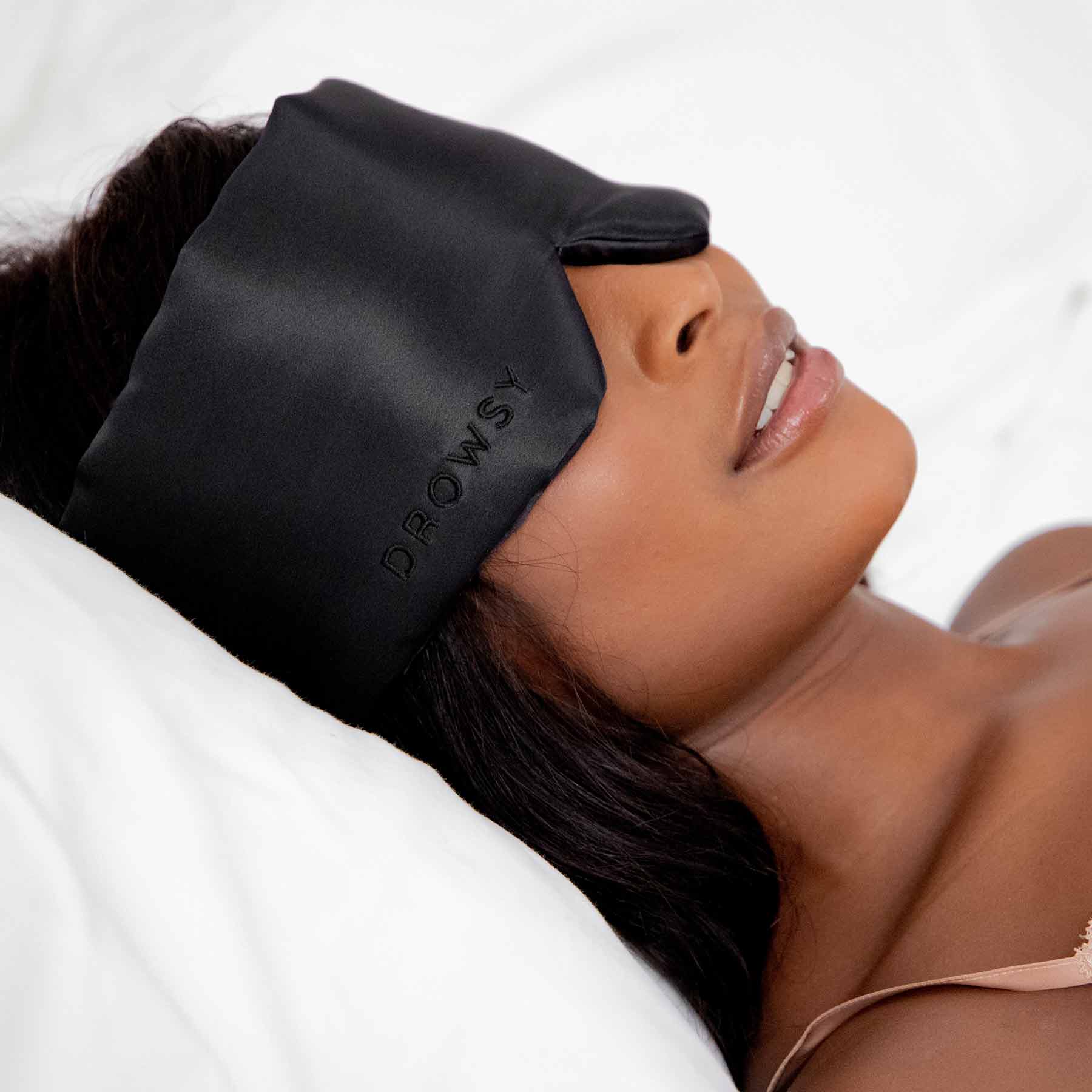 Model sleeping in bed with Drowsy Sleep Co. Black Jade mask covering her eyes