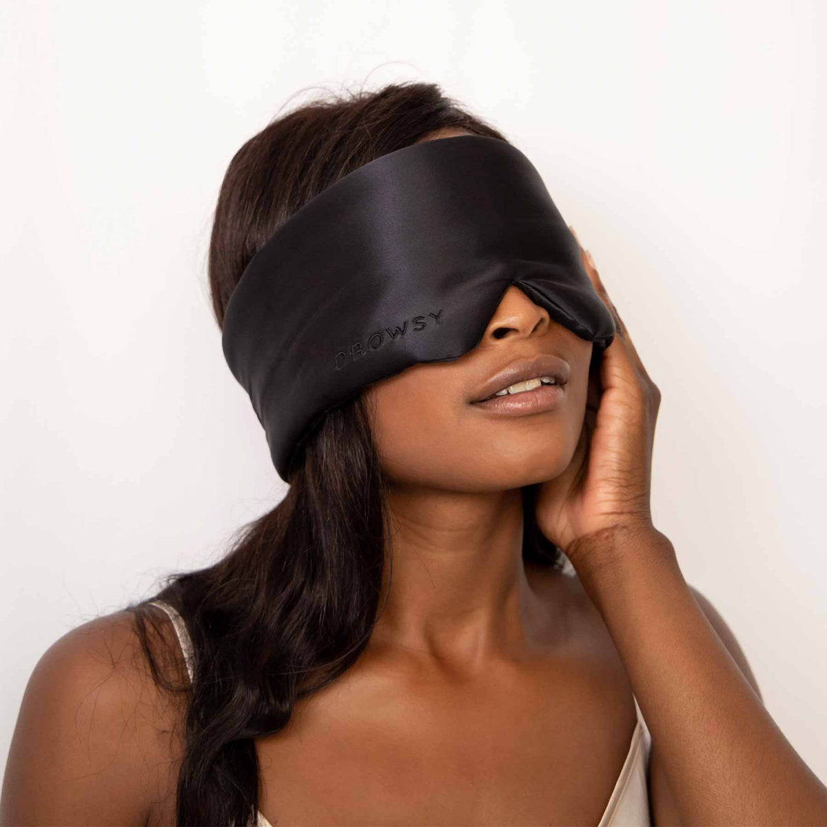 Model blocking out light using Drowsy Sleep Co Silk Mask