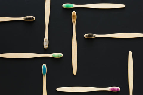 Bamboo toothbrushes on black background