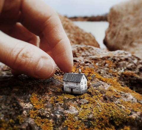 Miniature house on a rock by Michael Davydov