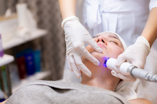 women undergoing laser treatment on her face