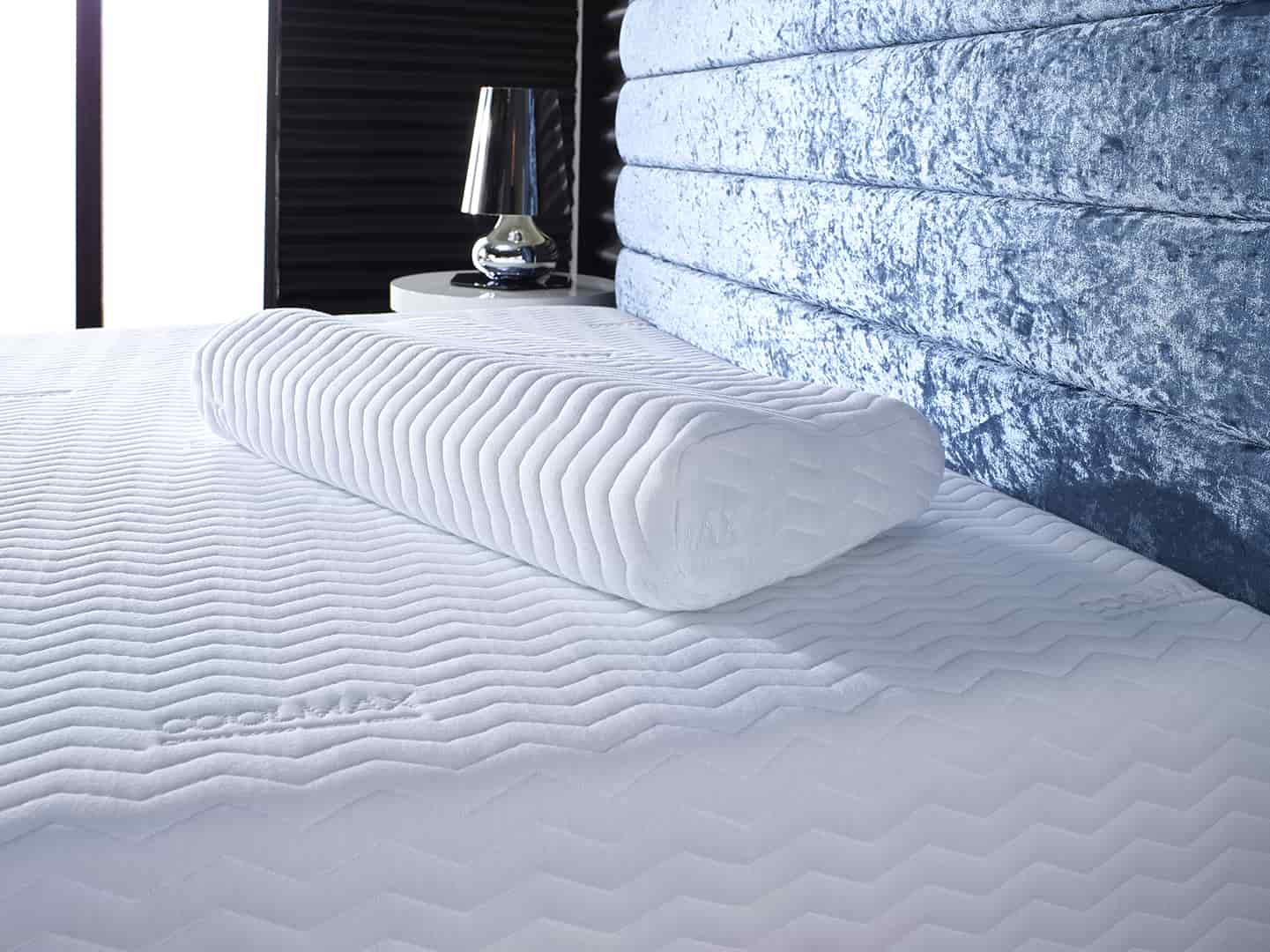 Coolmax contour memory foam pillow on bed