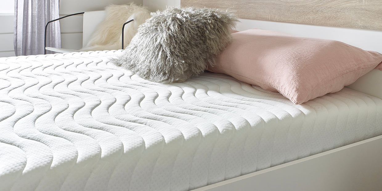 Close up of a memory foam mattress on a bed