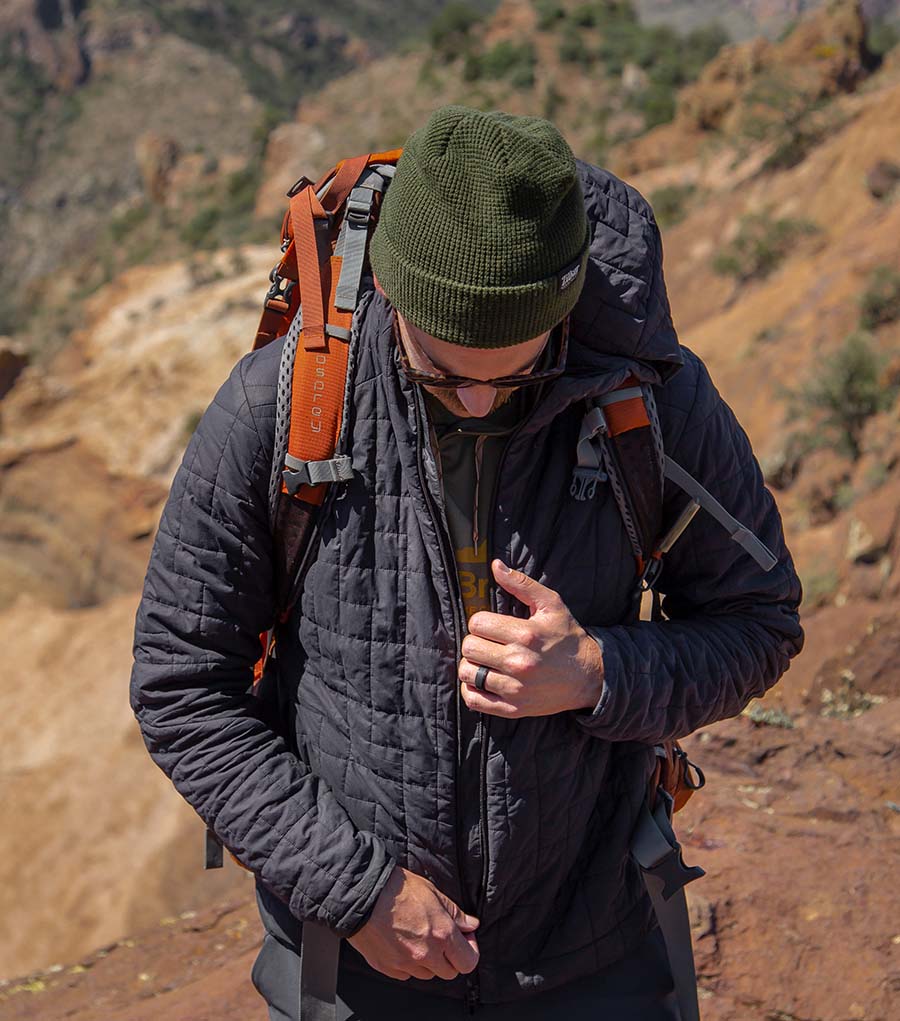 hiker pulling up jacket zipper