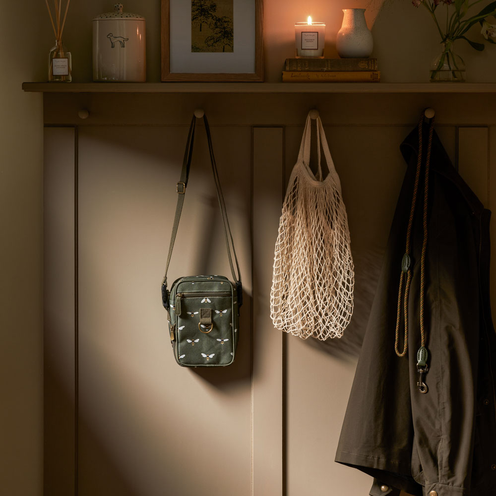 Sophie Allport's forest green dog walking bag hung up in boot room