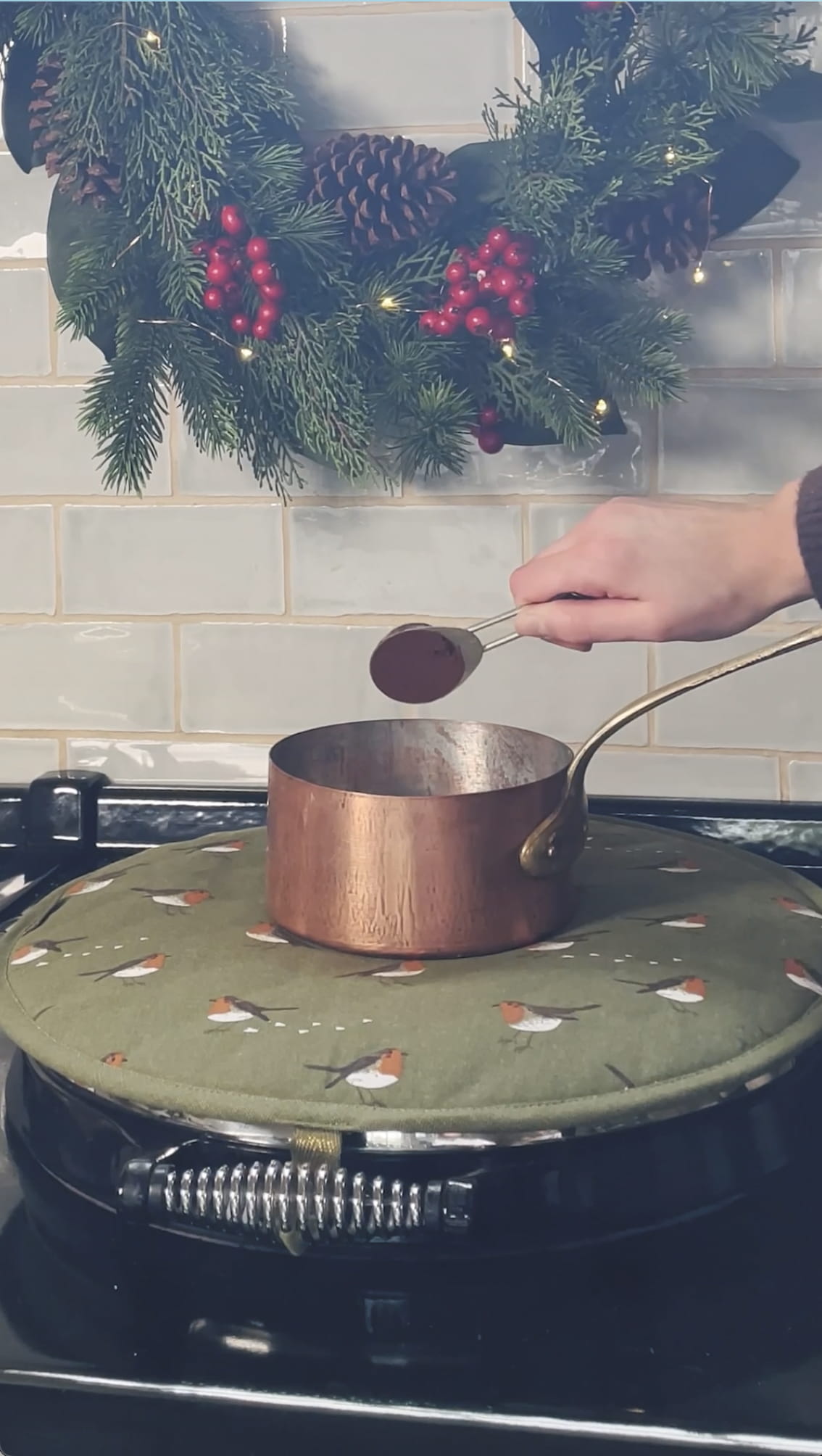 Pouring in cocoa powder - Choc-Orange hot chocolate recipe from Sophie Allport 
