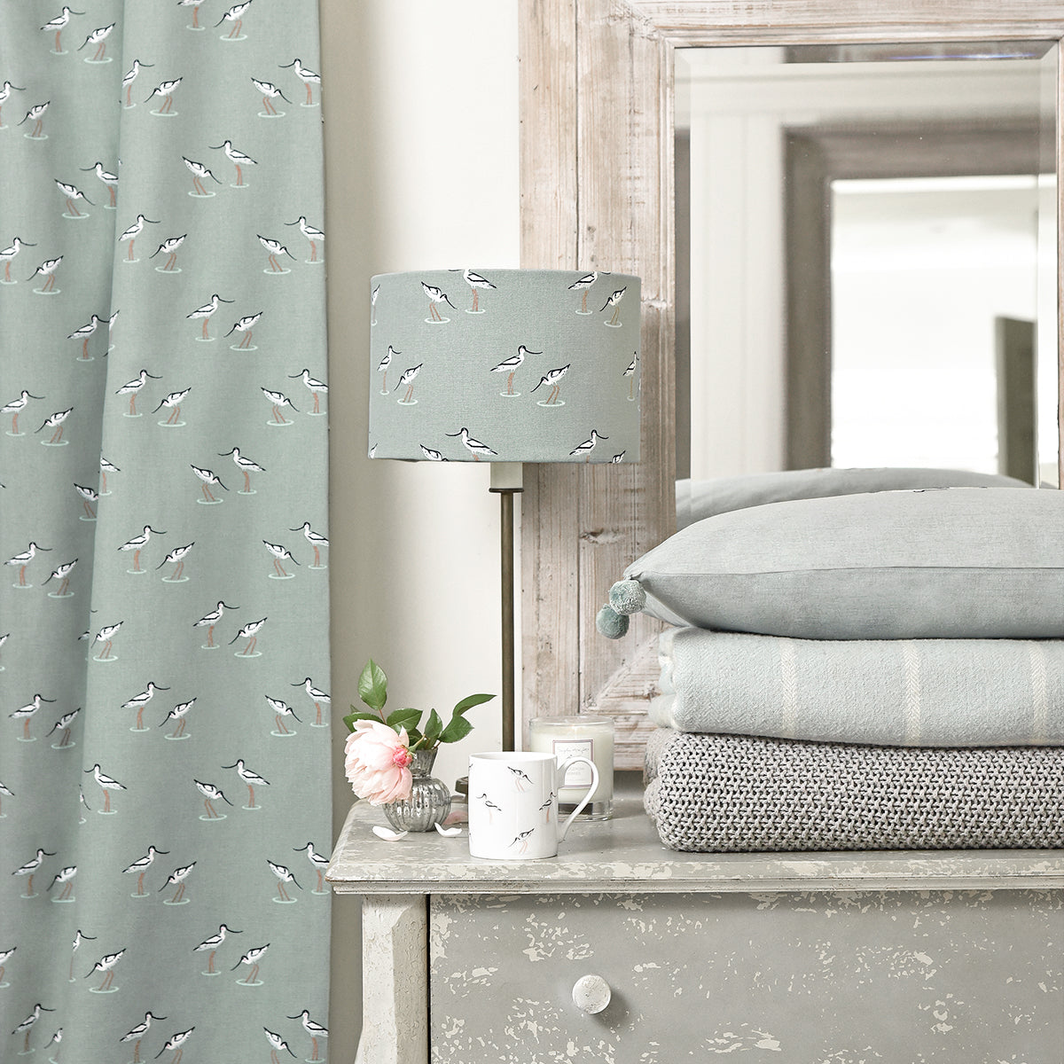 Sophie Allport's sea blue green fabric has been made into curtains and a lampshade.