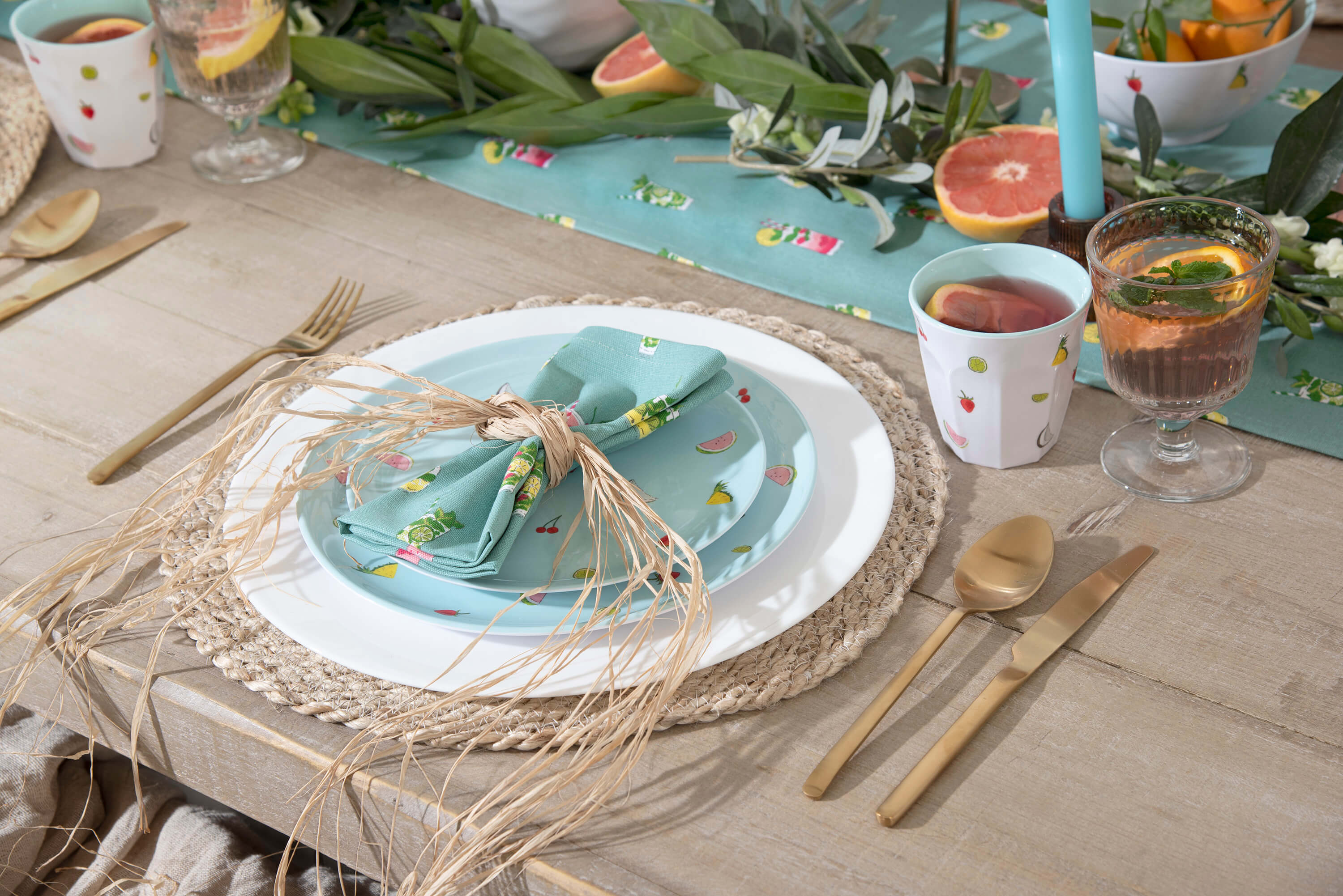 Table setting laid with summer inspired cocktail designed linens 