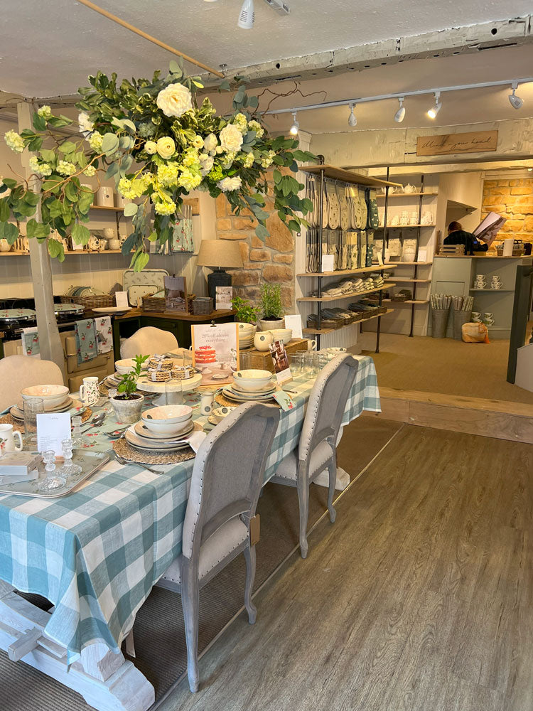 Sophie Allport Stamford Shop featuring table scape with a flower cloud above dining table and chairs plus decorated with Sophie Allport table linens
