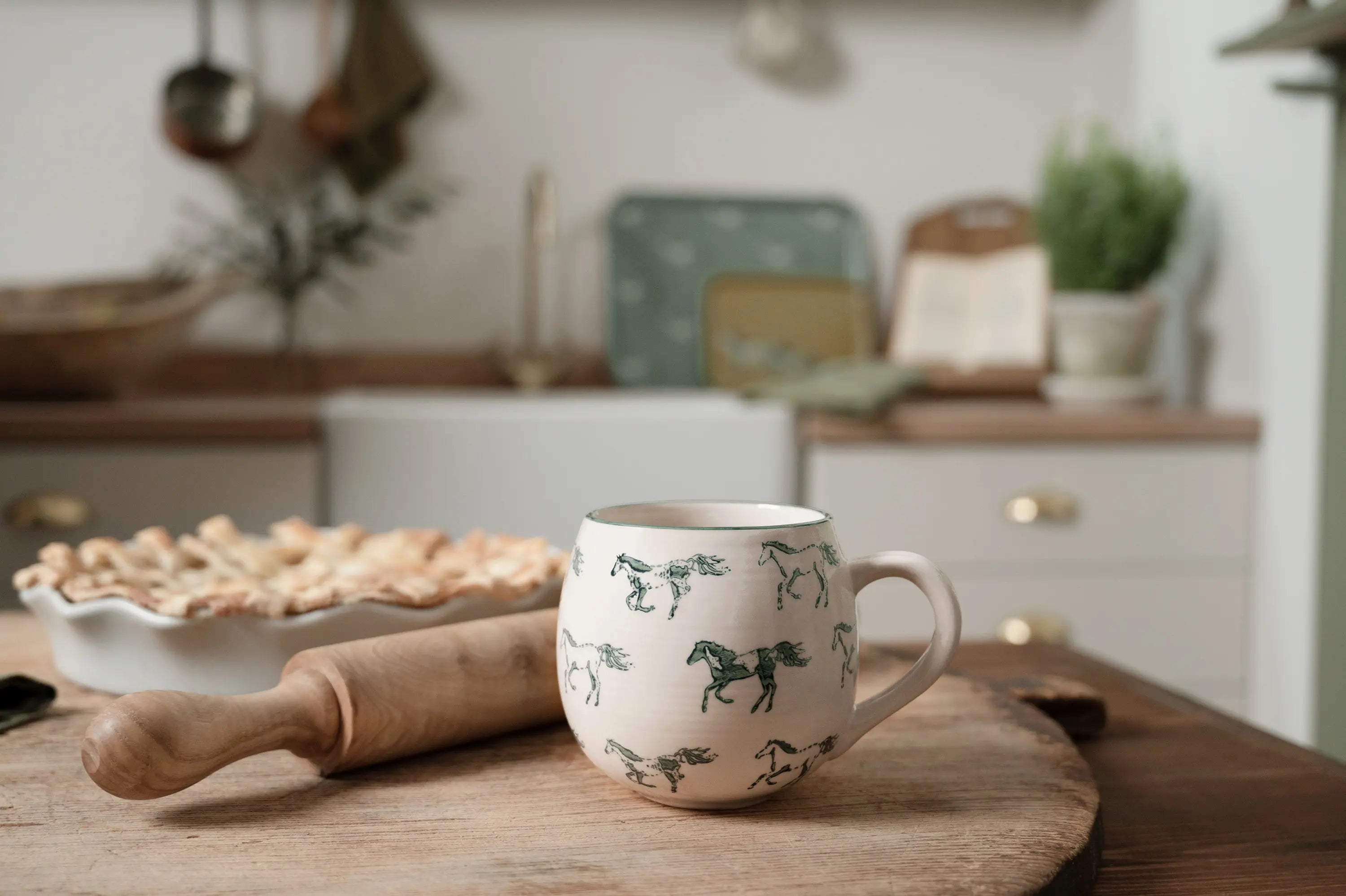 horse illustrations on a stoneware mug in a rustic country kitchen