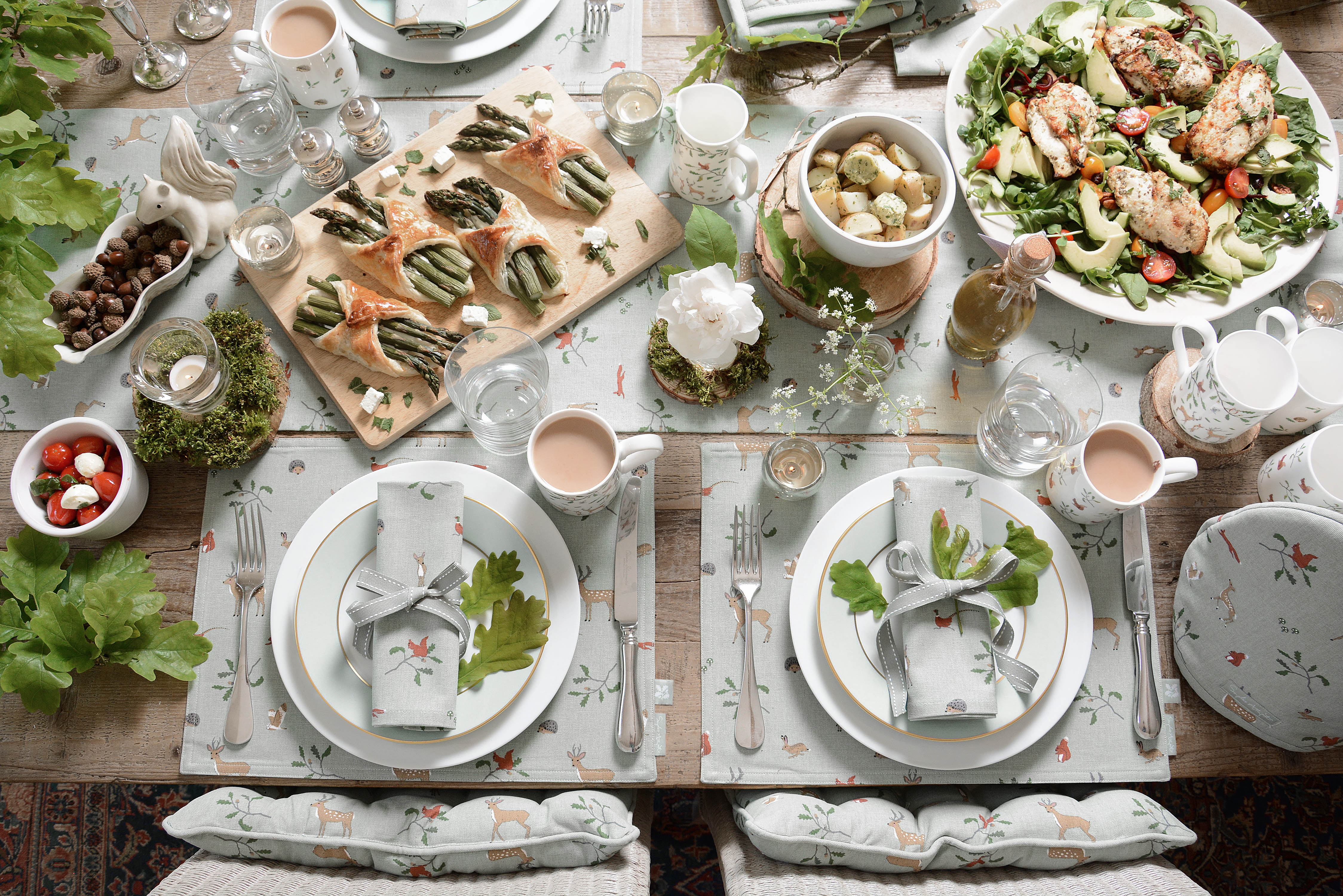 Picturesque woodland table setting full of food