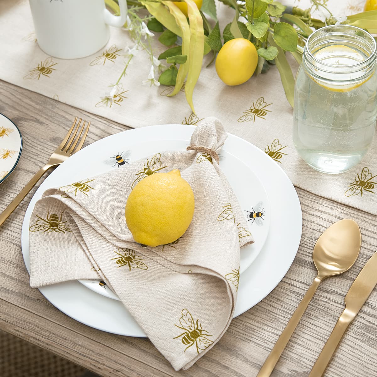 https://cdn.shopify.com/s/files/1/0201/1771/7092/products/bees-linen-lifestyle-table-set-up-fabric-plates-high-res-square-jpg.jpg?v=1664353093