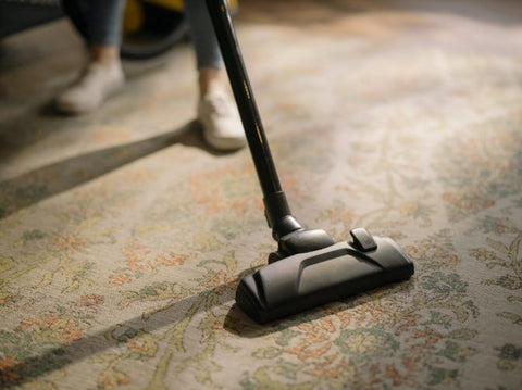 Photo of someone vacuuming.