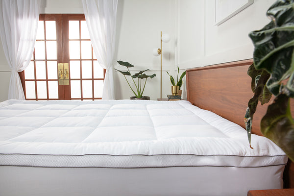 Side view of the Viscosoft Serene Hybrid Mattress Topper in a bedroom
