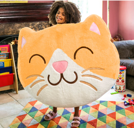 Young girl holding a giant Inflat-A-Pal in the shape of a kitten